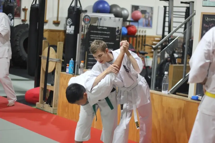 Aikido wrist lock being performed by teenager at